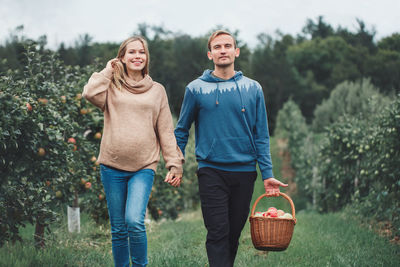 Full length of a smiling man holding basket