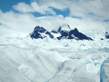 Scenic view of snow covered mountains against sky