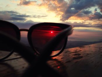 Reflection of clouds in sea at sunset