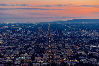 High angle view of illuminated buildings against sky during sunset