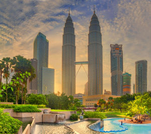 View of skyscrapers against cloudy sky