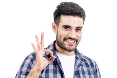 Close-up of handsome bearded man against white background