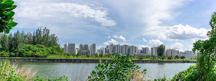 Panoramic view of river and buildings against sky