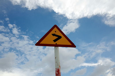 Low angle view of road sign against sky