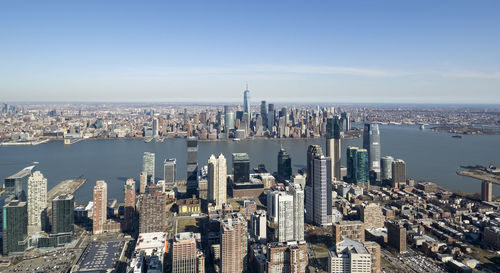 Aerial view of buildings in city against sky