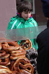 Teenage boy buying sweet food from vendor in city