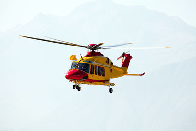 Low angle view of helicopter flying in sky