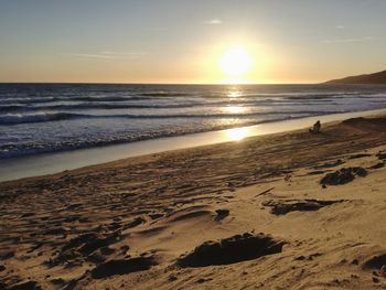 Scenic view of beach against sky during sunset