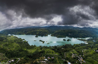 Scenic view of sea and mountains against sky