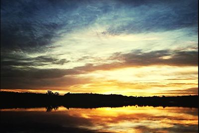 Scenic view of calm lake at sunset