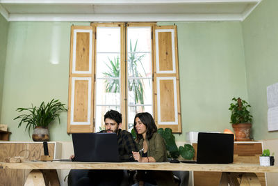 Couple sitting on table at home