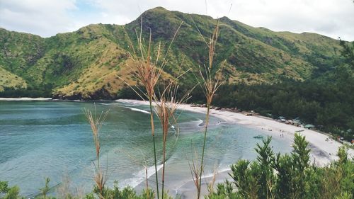 Scenic view of sea and mountains against sky