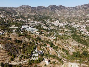 High angle view of houses amidst trees and mountains