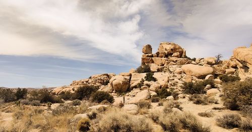 Low angle view of rock formations against sky