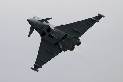 Low angle view of airplane flying against clear sky