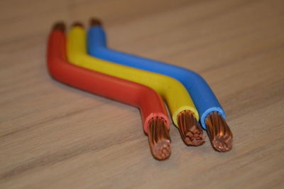 Close-up of colorful cables on wooden table