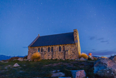 Exterior of temple against blue sky at night