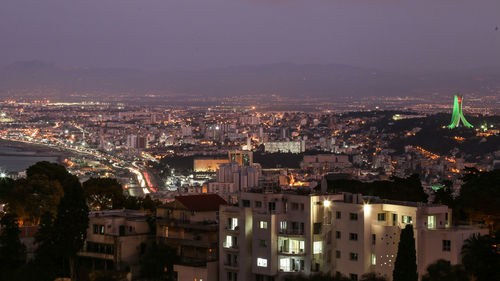High angle view of illuminated city buildings at dusk