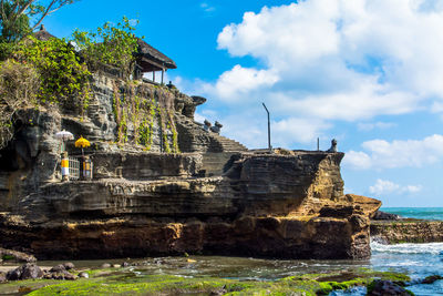 Old ruin by sea against sky