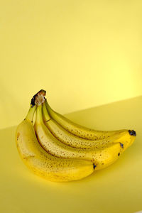 Close-up of yellow fruit banana against yellow background