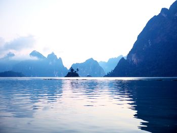 Scenic view of sea and mountains against sky