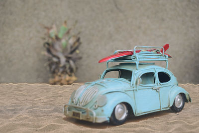 Close-up of toy car on sand