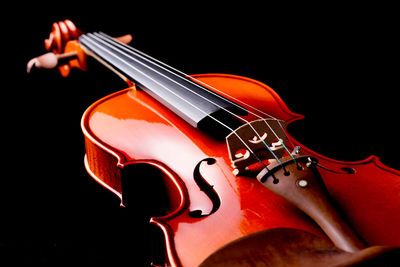 Close-up of guitar against black background