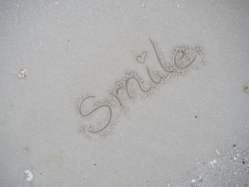 High angle view of heart shape on sand