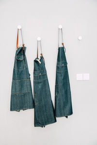 Clothes hanging against white wall