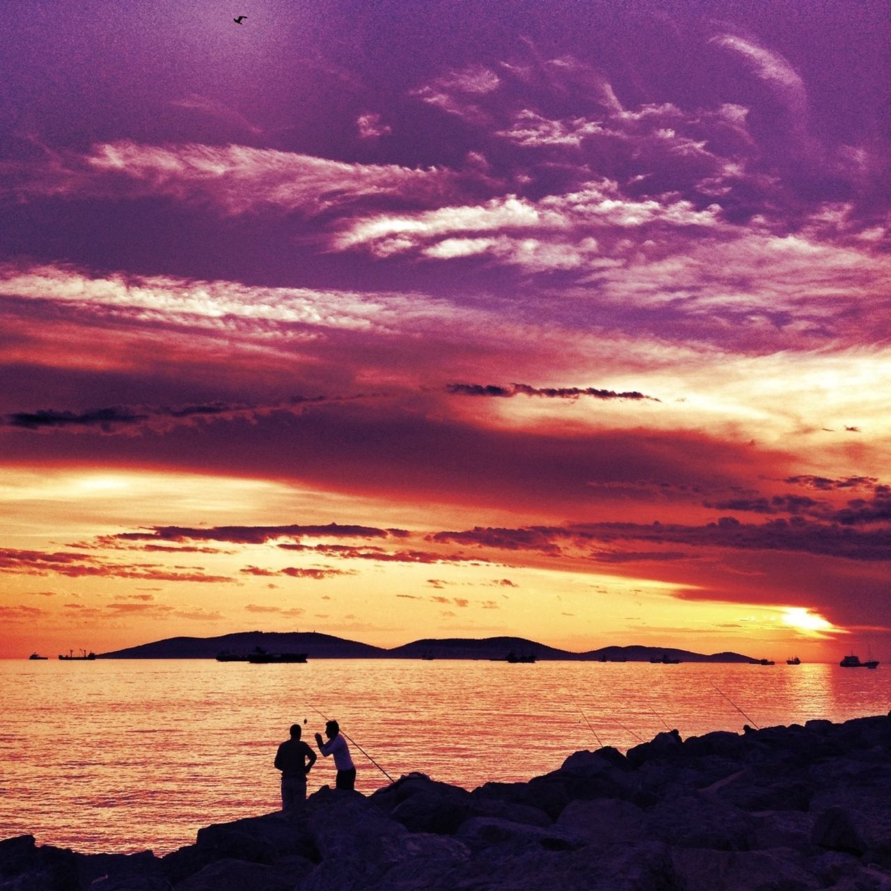 sunset, water, silhouette, sky, sea, scenics, cloud - sky, beauty in nature, orange color, tranquil scene, tranquility, lifestyles, leisure activity, horizon over water, men, beach, dramatic sky, idyllic