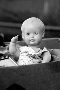 Close-up of old doll in container