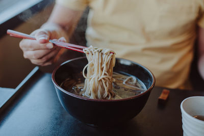 Midsection of person having soup