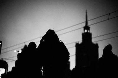 Low angle view of silhouette people in city