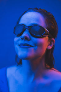 Close-up portrait of young woman wearing sunglasses