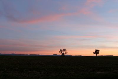 Silhouette landscape against sky during sunset