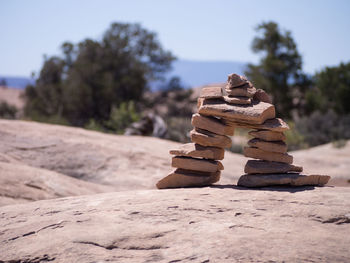 Close-up of stack on sand against sky