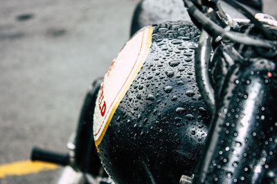 Close-up of wet bicycle during rainy season