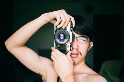 Close-up of man photographing with camera