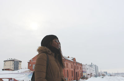 Rear view of woman standing in winter