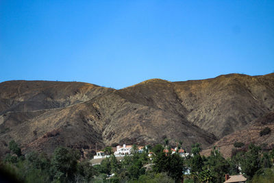 Scenic view of mountains against clear blue sky