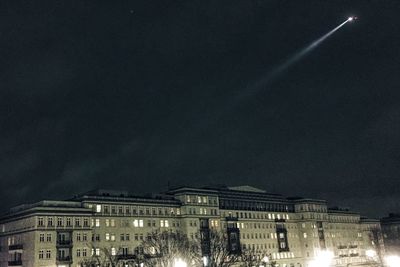 Low angle view of buildings against sky at night