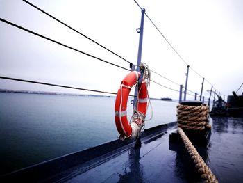 Boat moored on sea against clear sky