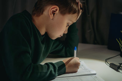 Young woman writing in book