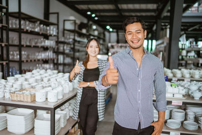 Portrait of smiling friends standing in store