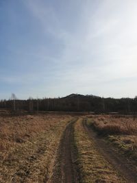 Dirt road along countryside landscape