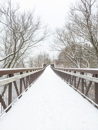 Footbridge over snow covered landscape