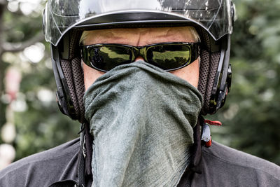 Close-up portrait of man covering face with handkerchief