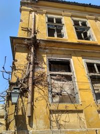 Low angle view of abandoned building against sky