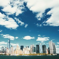 City skyline against cloudy sky