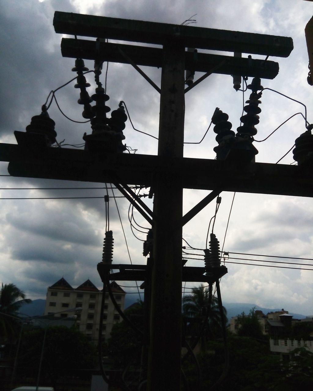 LOW ANGLE VIEW OF SILHOUETTE TOWER AGAINST CLOUDY SKY